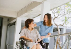 A woman in a wheelchair with her therapist to illustrate the concept of taking a medical loan for medical emergencies