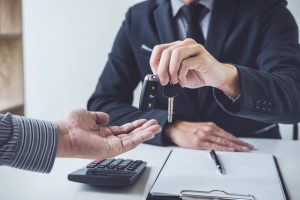 A customer receives the keys to his car after successfully taking out a Grab loan