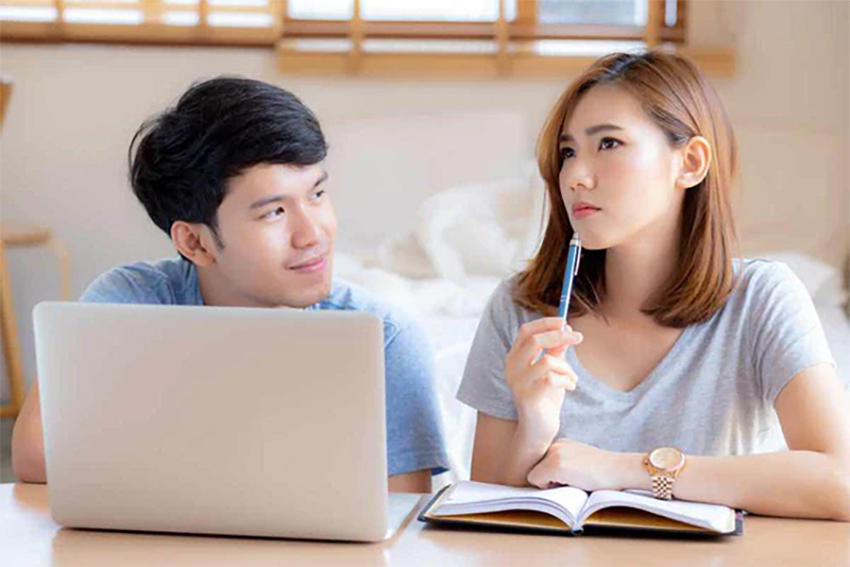 Young couple discussing personal loans with the lowest interest rate they can find in Singapore